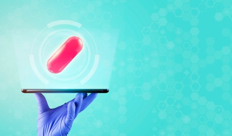 Digitale Darstellung des E-Rezeptes. Eine Rote Medikamenten-Pille schwebt oberhalb eines Tablets in der Luft.